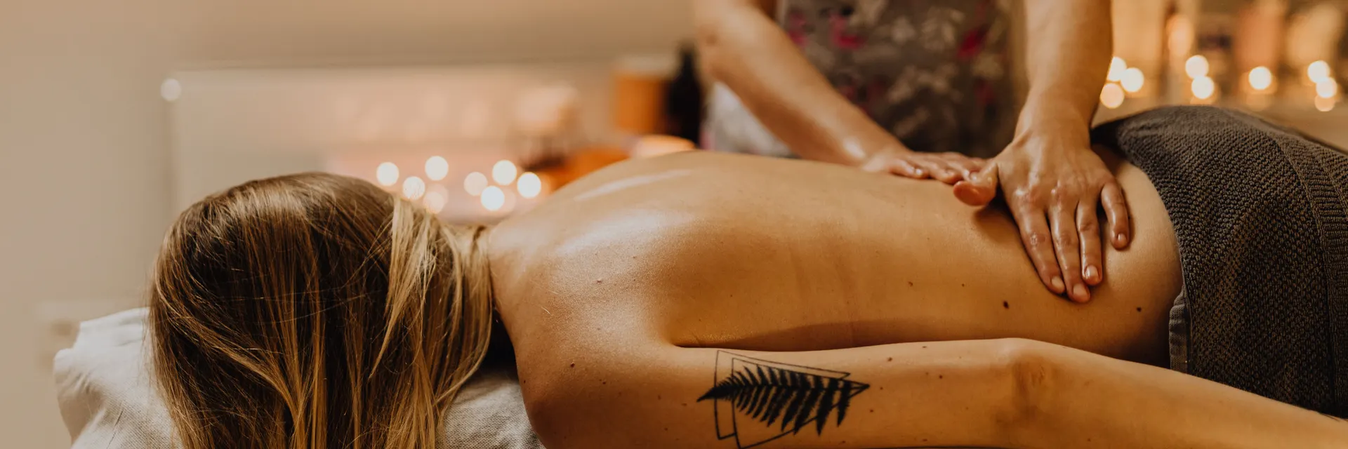 Back massage in a candlelit room